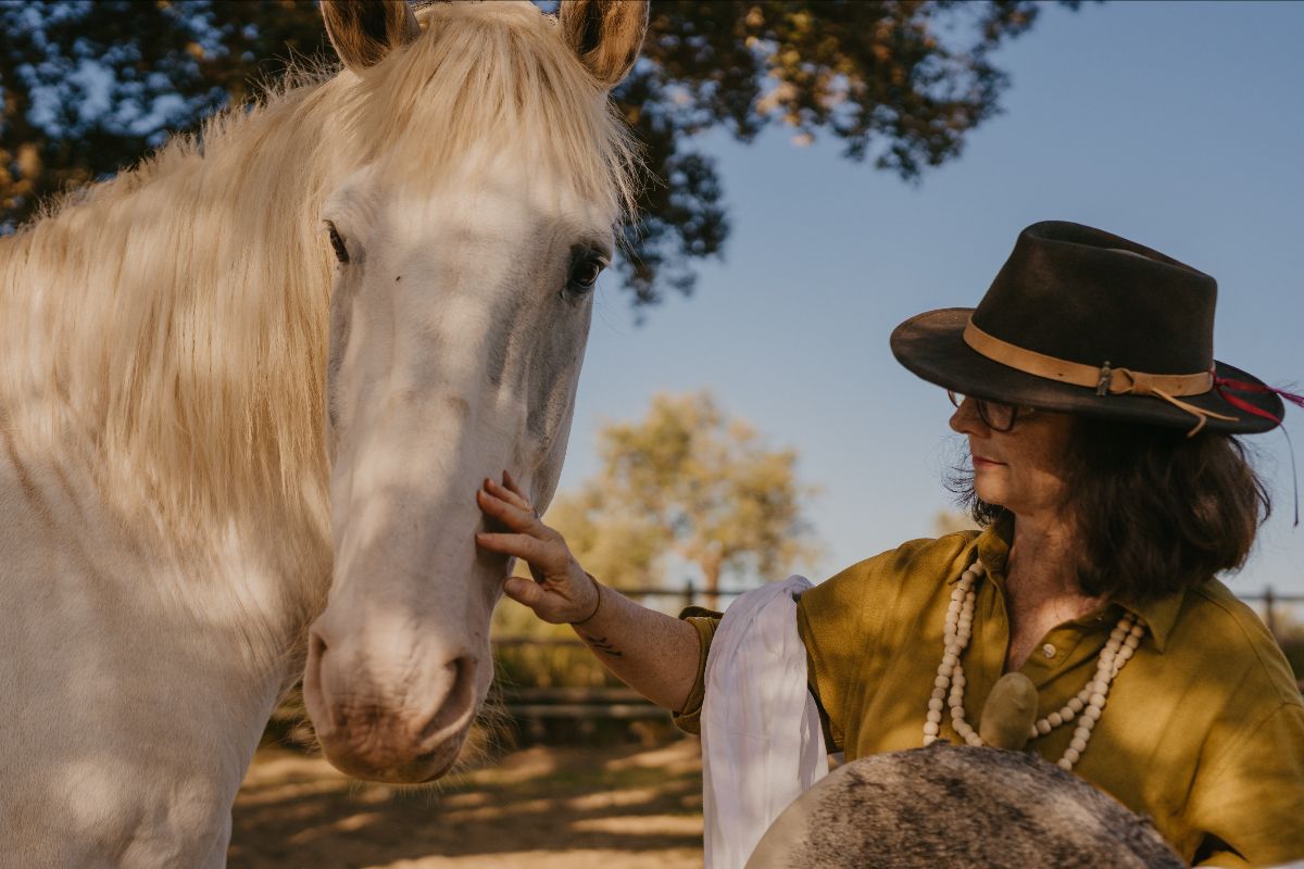 a woman and a white horse