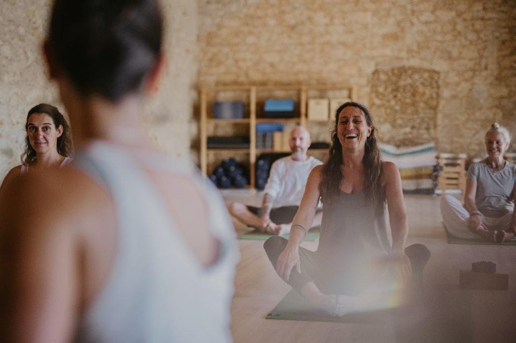 group of people having fun while doing yoga