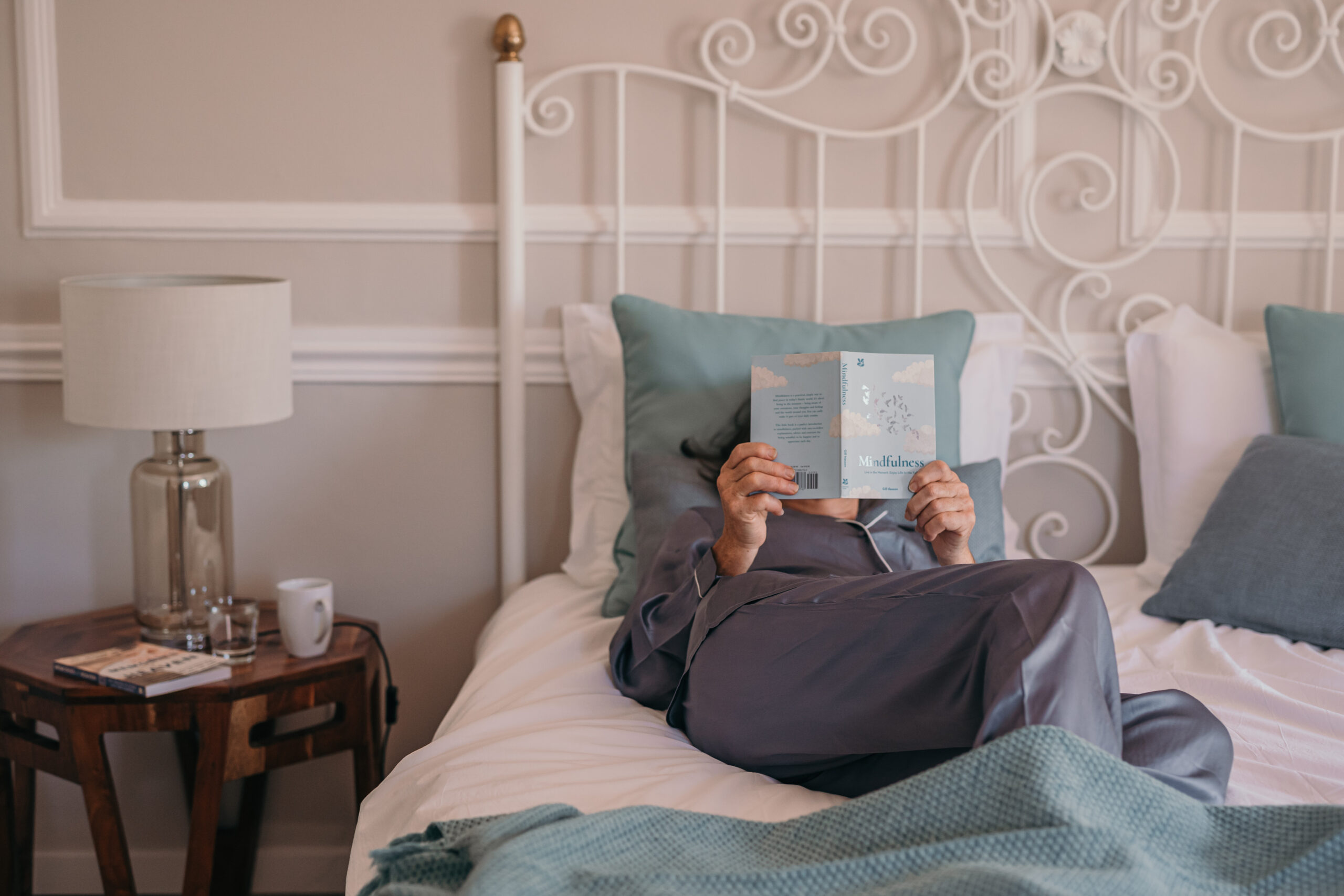 A woman reading a book on the bed